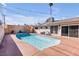 Open swimming pool with backyard, lounge chairs, palm trees, and view of home at , Las Vegas, NV 89121