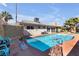 Inviting pool area with lounge chairs, palm trees, and a glimpse of the home's exterior at , Las Vegas, NV 89121