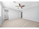 Bright bedroom boasts a ceiling fan, plush carpet, and an adjacent bathroom at 100 Grandview Dr, Henderson, NV 89002