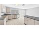 Open kitchen featuring wood-look flooring, neutral cabinets, and stainless appliances at 100 Grandview Dr, Henderson, NV 89002
