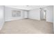 Open-plan living room features neutral carpet, a bright window, and a white front door at 100 Grandview Dr, Henderson, NV 89002