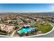 Expansive aerial view of a community featuring a pool, landscaping, and homes against a mountain backdrop at 10466 Smokewood Rd, Las Vegas, NV 89135