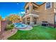 A backyard retreat with a pool, a grill, manicured lawn, and an outdoor dining area, ideal for relaxation and entertainment at 10466 Smokewood Rd, Las Vegas, NV 89135