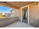 A private balcony with a neutral finish, a view of the neighborhood, and a glass door leading to the interior at 10466 Smokewood Rd, Las Vegas, NV 89135
