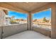 An open balcony featuring a textured neutral finish and views of neighborhood rooftops and distant mountains at 10466 Smokewood Rd, Las Vegas, NV 89135