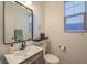 Bright bathroom featuring a sleek vanity, modern fixtures, and a large mirror, providing a clean and stylish space at 10466 Smokewood Rd, Las Vegas, NV 89135