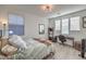 Bright bedroom with a desk, ample natural light, and light wood flooring at 10466 Smokewood Rd, Las Vegas, NV 89135