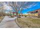 Scenic community park with walking paths, picnic areas, and a playground under a clear blue sky at 10466 Smokewood Rd, Las Vegas, NV 89135