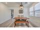Dining room with modern rustic furniture, wood floors, and natural light at 10466 Smokewood Rd, Las Vegas, NV 89135