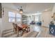 Well lit dining room with wood floors, modern furnishings and decorative lighting at 10466 Smokewood Rd, Las Vegas, NV 89135