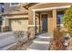 Home front entrance and two car garage with manicured desert landscaping at 10466 Smokewood Rd, Las Vegas, NV 89135