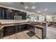 Spacious kitchen features dark cabinets, stainless steel appliances, and a connected living area at 10466 Smokewood Rd, Las Vegas, NV 89135