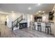 Open concept view of kitchen and bar seating area with hardwood floors at 10466 Smokewood Rd, Las Vegas, NV 89135