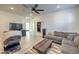 Open-concept living area with light wood floors, a comfortable sofa, and recessed lighting, creating a welcoming space at 10466 Smokewood Rd, Las Vegas, NV 89135