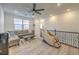 Bright living room with light wood flooring, a comfortable sofa, and a relaxing massage chair at 10466 Smokewood Rd, Las Vegas, NV 89135