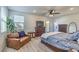 Spacious bedroom featuring a ceiling fan, ensuite balcony, and light wood floors creating a serene and comfortable atmosphere at 10466 Smokewood Rd, Las Vegas, NV 89135