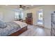 Spacious bedroom featuring access to a balcony, ceiling fan, and ample natural light, creating an inviting atmosphere at 10466 Smokewood Rd, Las Vegas, NV 89135