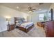 Comfortable bedroom features a large bed, soft carpet, and ample natural light, creating a relaxing and inviting atmosphere at 10466 Smokewood Rd, Las Vegas, NV 89135