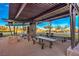 Covered picnic area with multiple tables and seating, providing a comfortable outdoor dining space at 10466 Smokewood Rd, Las Vegas, NV 89135