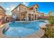 Inviting backyard pool and spa with landscaped surroundings of this two-story home at 10466 Smokewood Rd, Las Vegas, NV 89135