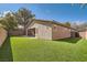 Backyard area with a well maintained yard with synthetic grass and privacy walls at 11125 Twilight Times Ct, Las Vegas, NV 89135