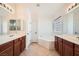 Bathroom featuring double sinks, cherry cabinets, and a relaxing soaking tub at 11125 Twilight Times Ct, Las Vegas, NV 89135