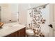 Bathroom featuring a sink with cherry cabinet, tile floor, and shower with floral curtain at 11125 Twilight Times Ct, Las Vegas, NV 89135