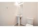 Simple half bathroom with pedestal sink, mirror, and standard toilet at 11125 Twilight Times Ct, Las Vegas, NV 89135