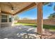 Backyard covered patio with stone flooring and a ceiling fan to enjoy the outdoor space at 11125 Twilight Times Ct, Las Vegas, NV 89135