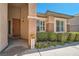 Inviting front entrance with a wooden door, manicured shrubs, and a welcome sign at 11125 Twilight Times Ct, Las Vegas, NV 89135