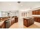 Stylish kitchen featuring granite countertops, stainless steel appliances, and an island cooktop at 11125 Twilight Times Ct, Las Vegas, NV 89135