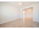 Open living room area with tiled floor and view to kitchen in modern home at 11125 Twilight Times Ct, Las Vegas, NV 89135