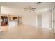 Bright, open living room with tiled floors, ceiling fan, and view into kitchen at 11125 Twilight Times Ct, Las Vegas, NV 89135