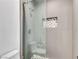 Modern bathroom shower enclosed with sleek glass, showcasing designer tile and built-in niche at 11775 Woodbrook Ct, Las Vegas, NV 89141