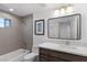 Modern bathroom featuring white countertop, dark wood vanity, tub and shower combination at 11775 Woodbrook Ct, Las Vegas, NV 89141
