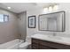 Bright bathroom with vanity, mirror, bathtub, and shower at 11775 Woodbrook Ct, Las Vegas, NV 89141