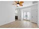 Bright bedroom featuring wood floors, ceiling fan, and an en suite bathroom at 11775 Woodbrook Ct, Las Vegas, NV 89141