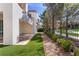 Modern home showcasing a manicured lawn and patio area with a view of the golf course at 11775 Woodbrook Ct, Las Vegas, NV 89141