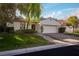 Charming single-story home boasts a two-car garage, landscaped yard, and a welcoming entrance at 11775 Woodbrook Ct, Las Vegas, NV 89141