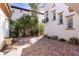 Private outdoor patio with brick pavers and lush greenery, perfect for relaxation and entertaining at 11775 Woodbrook Ct, Las Vegas, NV 89141