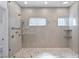 Contemporary shower featuring glass enclosure, tiled walls, dual shower heads, and built-in shelving at 11775 Woodbrook Ct, Las Vegas, NV 89141