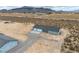 A high aerial shot of the home and detached garage, with the mountains in the distance at 1330 W Gee St, Pahrump, NV 89060