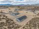 High aerial view of a desert home with outbuilding; shows vastness of the property at 1330 W Gee St, Pahrump, NV 89060