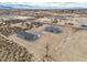 Overhead aerial displays desert home and detached garage in a vast open setting at 1330 W Gee St, Pahrump, NV 89060