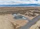 Drone shot of a home and detached garage; shows the long driveway and desert landscape at 1330 W Gee St, Pahrump, NV 89060