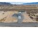 An elevated view highlights the home and detached garage on a large desert parcel at 1330 W Gee St, Pahrump, NV 89060