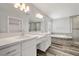 Bright bathroom featuring double sinks, luxurious soaking tub and glass shower, complete with modern lighting at 1330 W Gee St, Pahrump, NV 89060