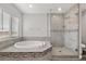 Beautiful bathroom featuring tiled shower, soaking tub with decorative trim, and window at 1330 W Gee St, Pahrump, NV 89060