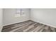 This bedroom features wood-look floors, a window, and neutral colored walls at 1330 W Gee St, Pahrump, NV 89060