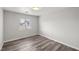 Neutral bedroom showcasing wood-look floors, light walls, and a bright window at 1330 W Gee St, Pahrump, NV 89060